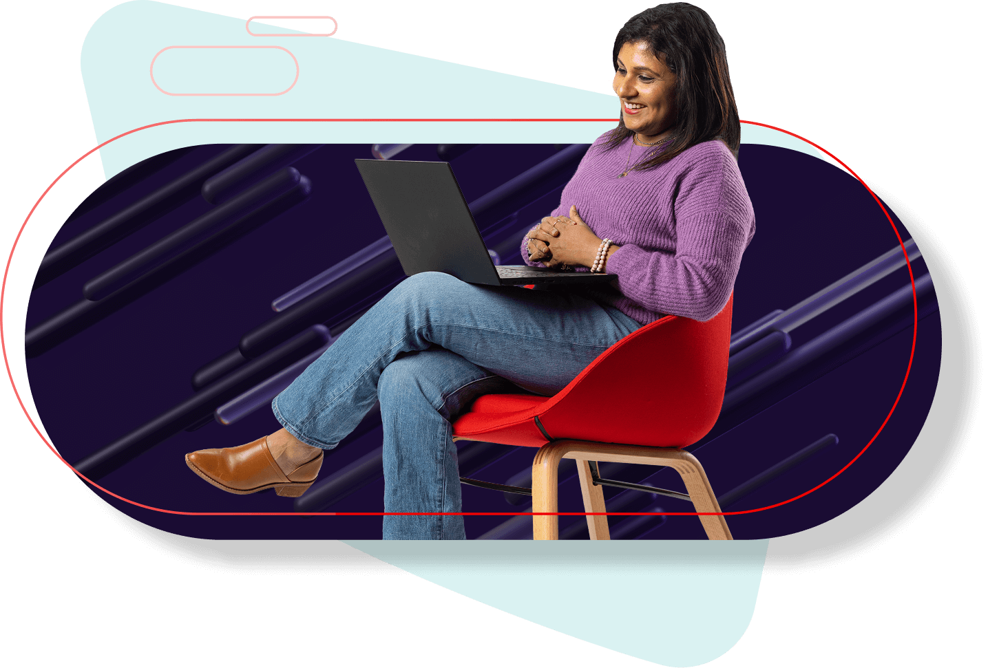 A woman sitting in a red chair happily typing on a laptop